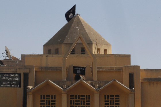 Flags of the al Qaeda-linked Islamic State of Iraq and the Levant are hung on The Martyrs Church in Raqqa, Syria, on Sept. 27.