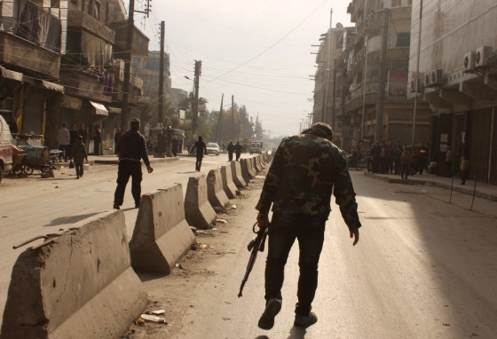 A rebel fighter walks in a street of the northern Syrian city of Aleppo.