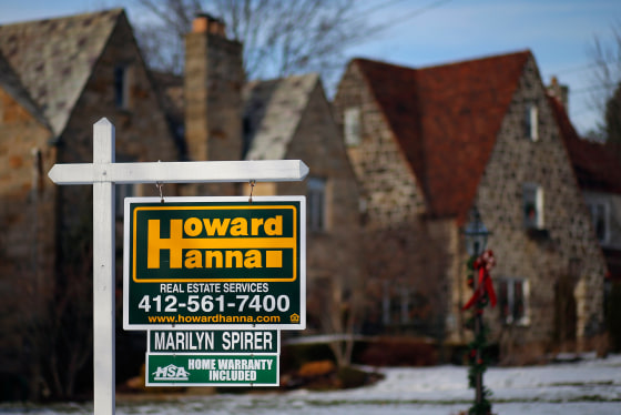 In this Thursday, Jan. 9, 2014, photo, a for sale sign hangs in front of a house in Mount Lebanon, Pa. The National Association of Realtors releases e...
