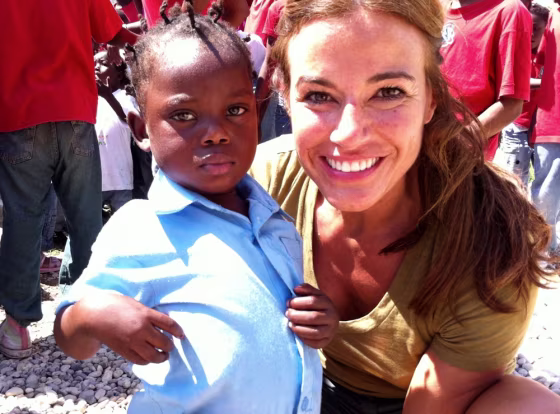 Kelly Bensimon with one of the children at Orphelinat bon Samaritain (The Good Samaritan Orphanage) in Haiti where she helped fund a clean water well through Generosity Water.