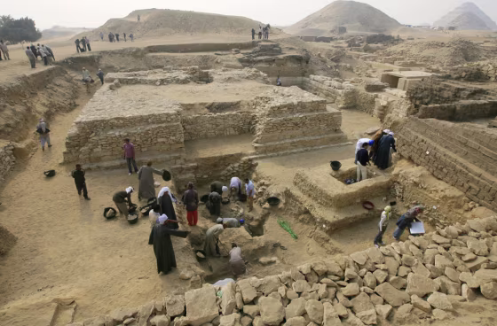 Image: Egyptian archaeologists work at an ancient burial ground