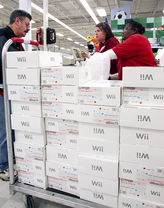 Image: Donnie Dykes of Berkley, Mich., left, purchases a Nintendo Wii gaming system at a Meijers store in Troy, Mich., on Black Friday