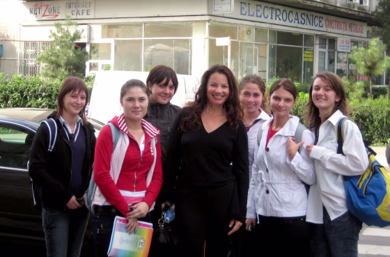 Image: Fran Drescher with students in Romania.