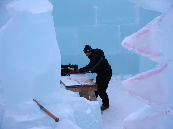 A worker carves a block of ice at Fairbanks’ Ice Park in Fairbanks,