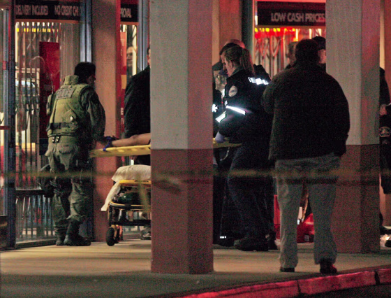 Image: Paramedics and SWAT team officers carry out a boy on a stretcher after being rescued from the a Chinese restaurant
