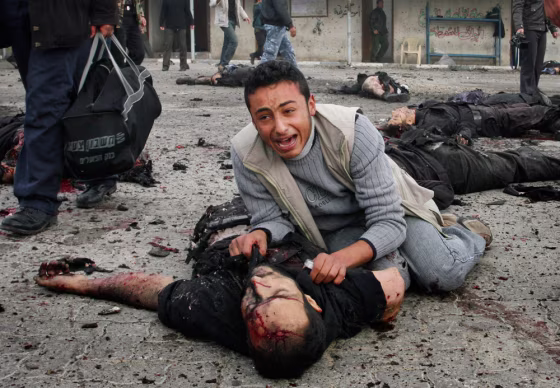 A Palestinian man reacts over the body of a member of the security forces of Hamas at the site of an Israeli missile strike at the security headquarters in Gaza City on&nbsp;Saturday.