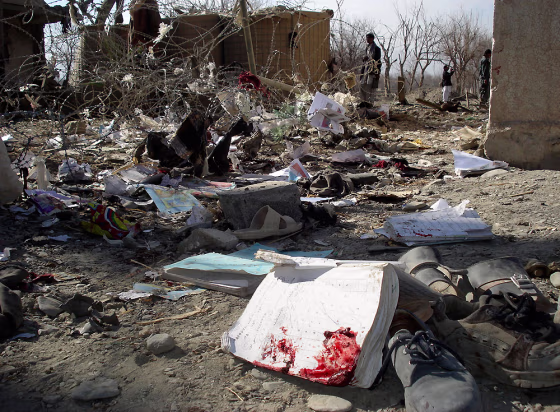 Image: School textbooks and shoes are seen on the ground after a suicide attack in Khost province