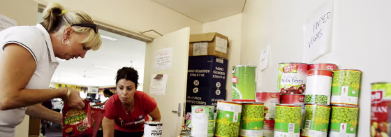 Volunteers Debbie Neave, left, and Farrah Mansour organize donations of food in a distribution center in Whittlesea, Australia&nbsp;on Feb. 19.