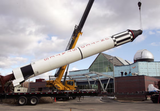 A replica of the Redstone rocket and Mercury capsule that sent Alan Shepard, the first American into space,&nbsp;is lifted in Concord, N.H. The McAuliffe-Shepard Discovery Center will open March 6 to carry on the legacy of two New Hampshire space heroes: Alan Shepard and Christa McAuliffe. 
