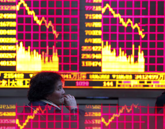 Image: Electronic board showing stock information at a brokerage house in Shanghai