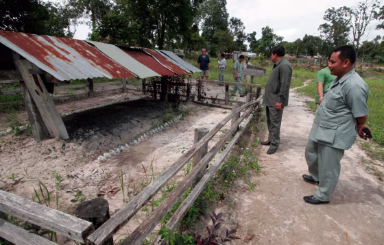 A group of unidentified Cambodian officials tour the cremation site of Khmer Rouge leader Pol Pot near Anlong Veng, Cambodia. A $1 million tourism master plan is being finalized to preserve and protect 15 Khmer Rouge sites, and charge admission. 