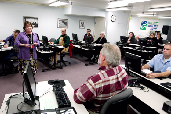 Sheila McQueen, a workforce development specialist,&nbsp;talks with jobseekers at&nbsp;a job club at WorkSource Portland Metro East on March 31 in&nbsp;Portland, Ore. 