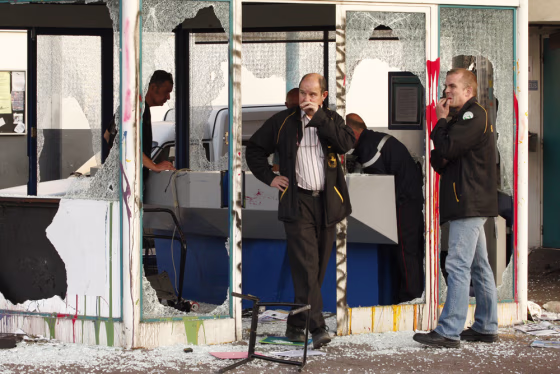 Image: Employees of Continental tyre factory look at the guard post