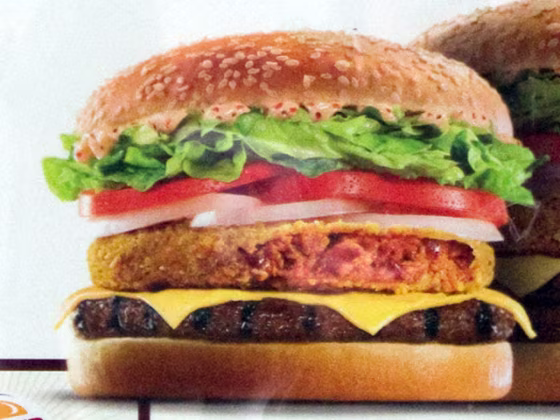 Image: A Burger King advertisement which has offended Mexican officials hangs in a store window in central Madrid