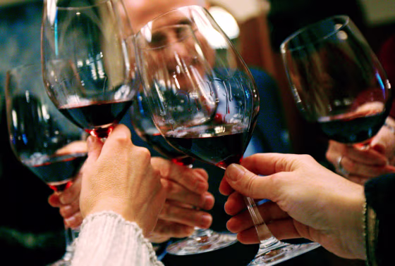 People raise their glasses in a toast at a luncheon in New York