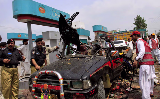 Image: Police examine a truck after a bomb blast in Pakistan