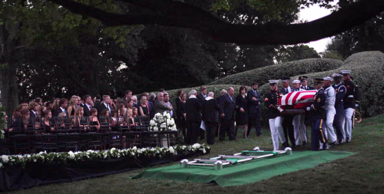 Image: The Kennedy family gathers around the grave site as an Honor Guard carries the casket of Sen. Ted Kennedy at Arlington National Cemetery, in Arlington, Va.