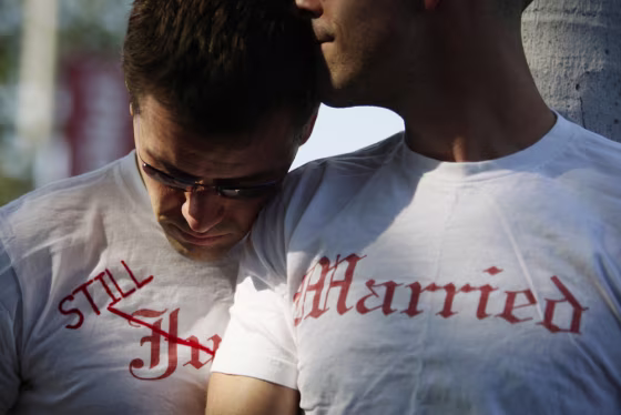 Image: Gay couple Ethan Collings and his spouse Stephen Abate hug