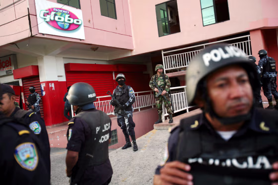 Image: Soldiers stand guard outside a radio station closed by the government