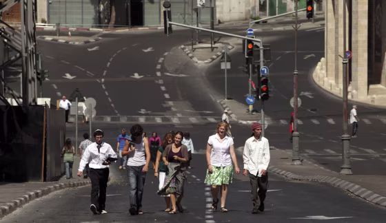 Image: People walk along an empty street during the Jewish holiday of Yom Kippur in Jerusalem