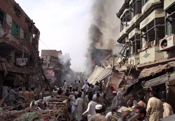 Image: Residents, rescue workers and security officials gather after a bomb explosion in Peshawar
