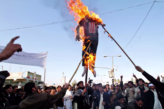 Image: An effigy of President Obama is burned during a protest in Afghanistan