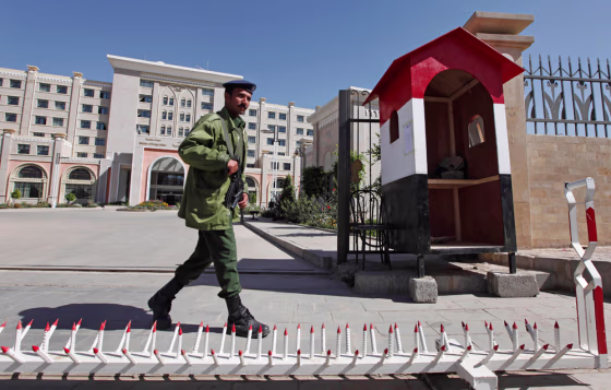Image: a soldier guards the gate of the Yemeni Foreign ministry in San'a, Yemen.