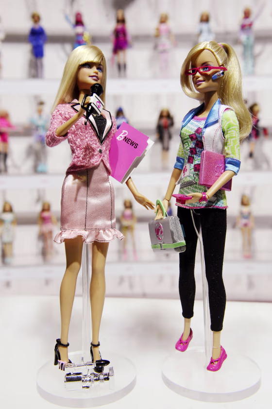 Image: Mattel's newly-introduced News Barbie and Computer Engineer Barbie are shown in front of a display of career-doll Barbies at the Toy Fair in New York