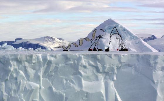 Image: A pair of metal sculptures is seen on an iceberg near the town of Uummannaq in western Greenland
