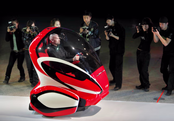 Image: An Electric Networked-Vehicle is driven by a General Motors' staff member during an event to unveil its new concept car in Shanghai