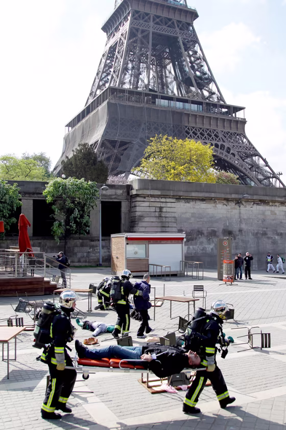 Image: French firemen give first aid to mock injured people as they conduct a drill exercise on terror attacks near the Eiffel Tower in Paris