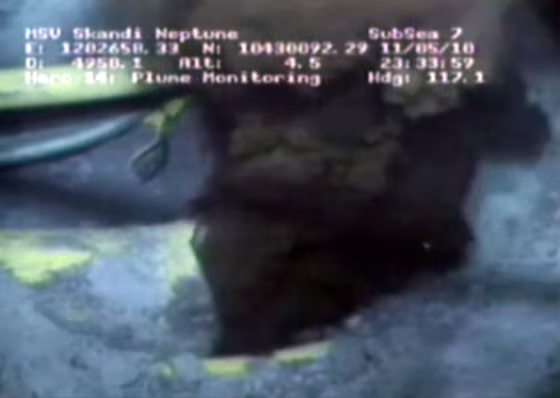 Image: Oil spewing from a yellowish, broken pipe