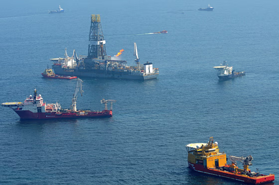 Image: Offshore supply vessels assist and observe the worksite of the Deepwater Horizon oil rig