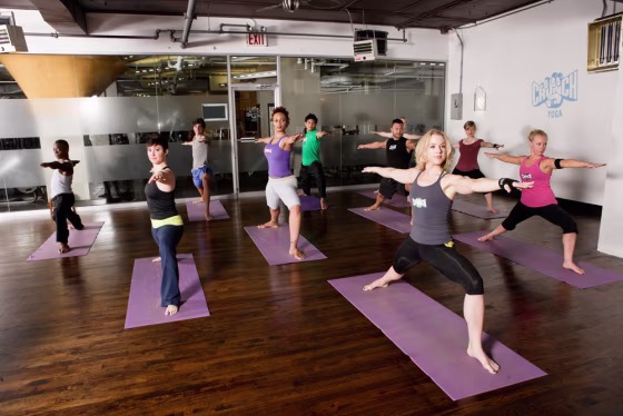 Image: A class posing in a hot yoga room
