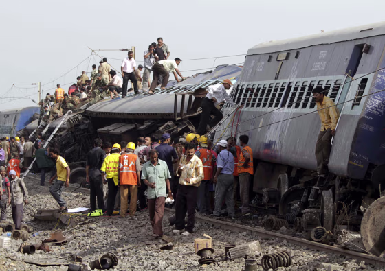Image: Rescue workers gather at the scene of a train crash