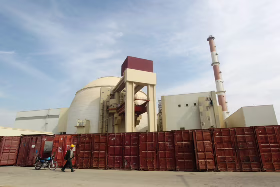 Image: Russian worker walks past Bushehr nuclear power plant, 1,200 km south of Tehran