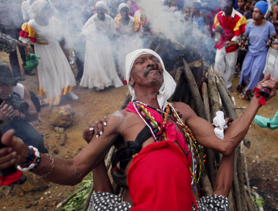 A Santero priest prays during a ceremony in honor of slaves rebelliousness. Cuban music helps to induce an altered state of consciousness for some practitioners of Santería hoping to connect with the spirits.