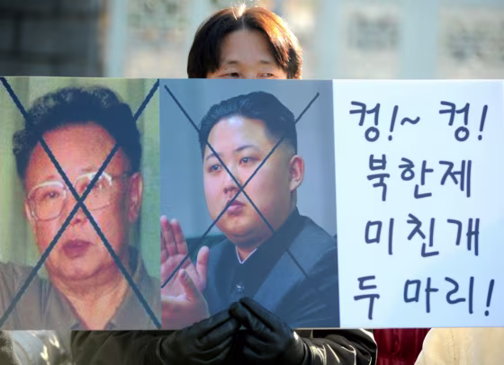 Image: A South Korean activist holds a placard
