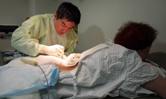 Dr. Roger Lo removing a tumor that he hopes will help researchers find drugs to treat relapsing cancer patients.