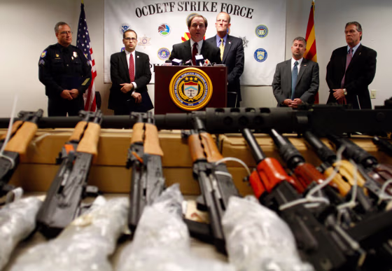 Image: District of Arizona United States Attorney Dennis Burke \speaks about recovering weapons from defendants accused of trafficking illegal firearms to Mexican drug cartels during a news conference in Phoenix