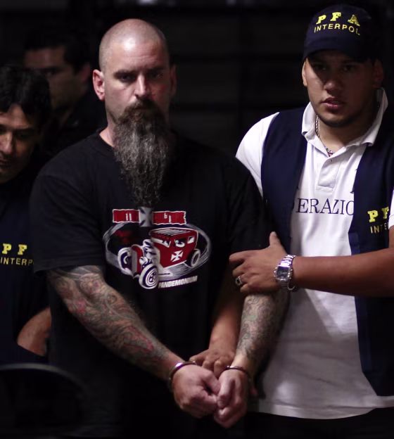 Image: Paul Eischeid from the U.S. is escorted by Argentine federal agents after being arrested, as he leaves a courthouse in San Isidro