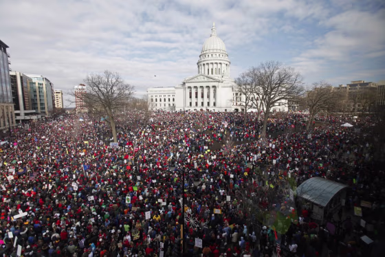 Image: Massive crowds gather to see 14 democratic senators that left state to protest bill proposed by Gov. Walker as crowds continued to protest at the Wisconsin State Capitol in Madison