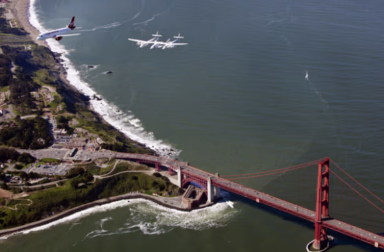A new Virgin America A320 aptly named "My Other Ride is a Spaceship" flies in tandem with SpaceShipTwo and its mothership White KnightTwo over the Golden Gate Bridge on Wednesday. The aircraft&nbsp;landed at San Francisco International Airport as the first aircraft to arrive at the new $388 million, 640,000-square-foot Terminal 2. 