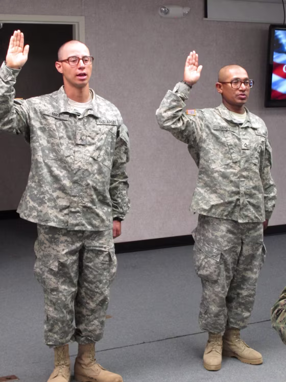 Image: Army Pvt. Jovany Mira, of Colombia, left, and Pfc. Shoumendra Nandy, of Bangladesh, take the oath to become U.S. citizens, at Fort Jackson, S.C.