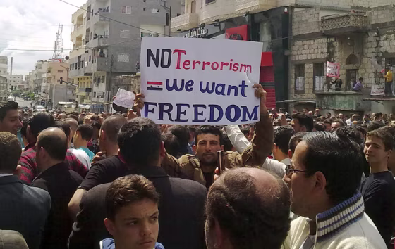 Image: Syrian anti-government protesters taking part in a demonstration in Banias in northeastern Syria