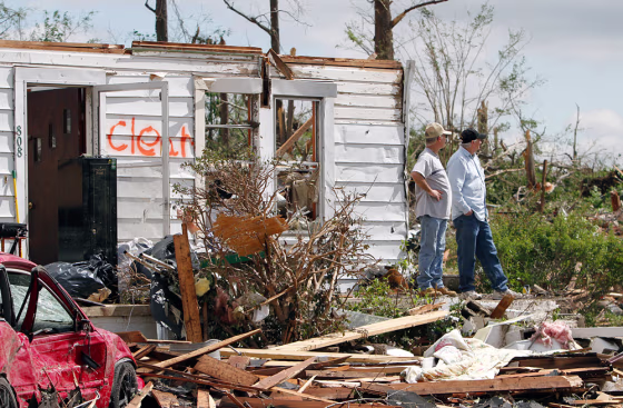 Image: People look at tornado damage