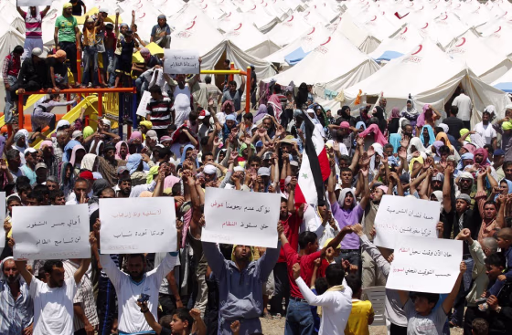 Image: Syrian refugees demonstrate after Friday prayers at a refugee camp in the Turkish border town of Boynuyogun in Hatay province