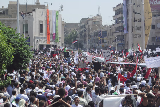 Image: People take part in a protest against President Bashar al-Assad after Friday prayers in Hama