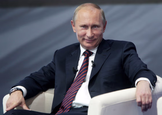 Image: Russian Prime Minister Vladimir Putin smiles while attending a \"United Russia\" party regional conference in the Ural Mountains city of Yekaterinburg