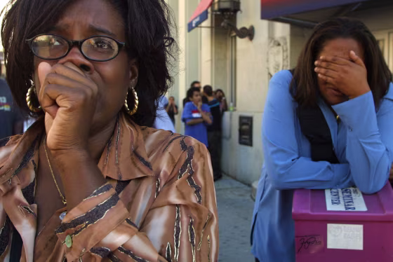 Image: Women react as they witness the collapse of the Two World Trade Center building, or South Tower.
